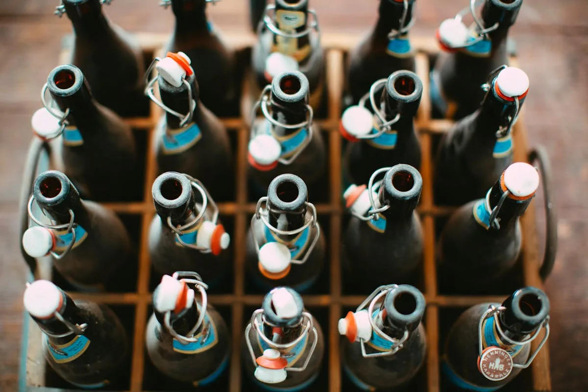 Swing-top bottles in a wooden crate ready for homebrew bottling