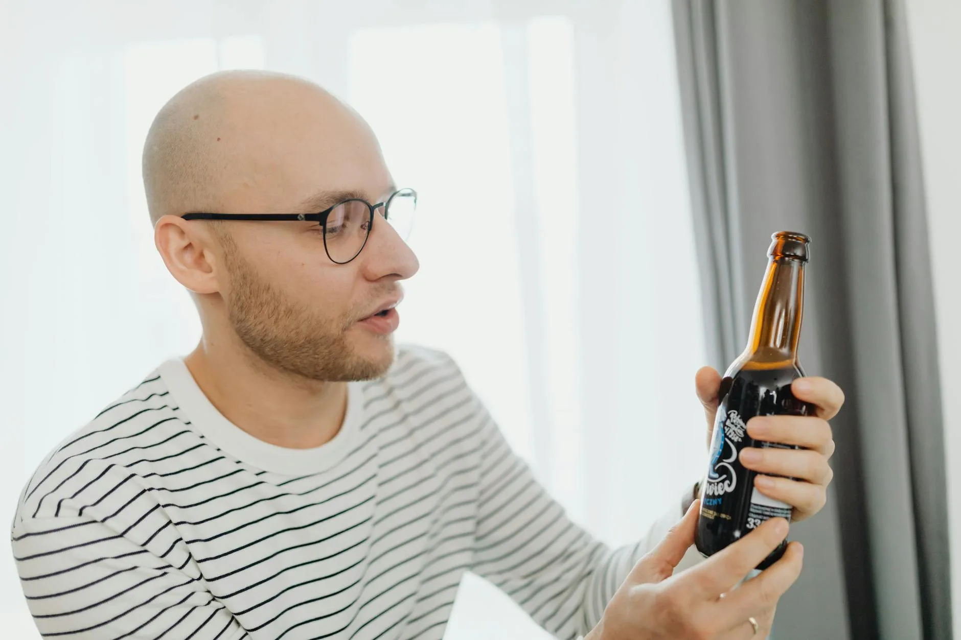 Man examining a bottle of craft beer