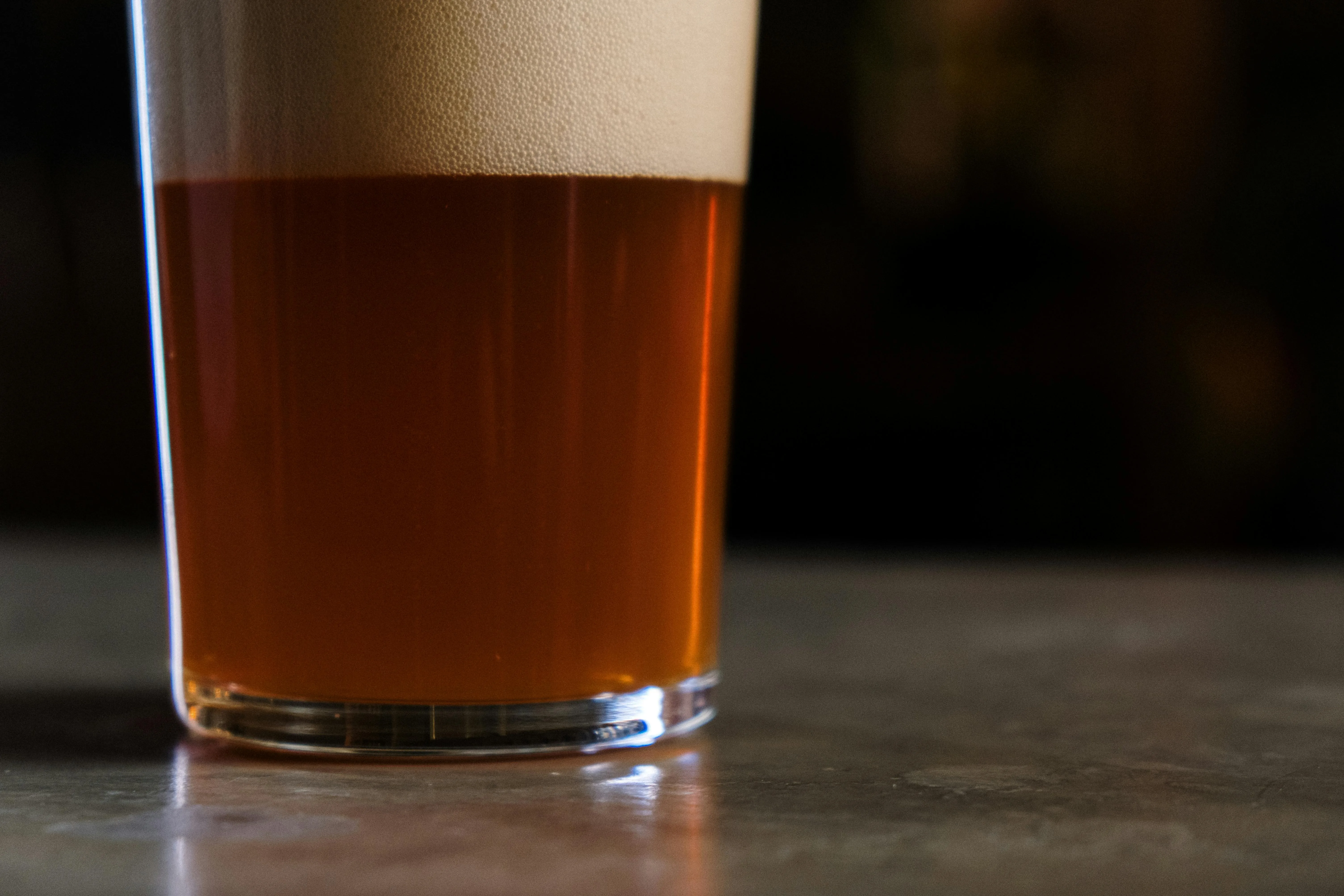 Amber homebrew beer with creamy foam head showing the result of proper water chemistry