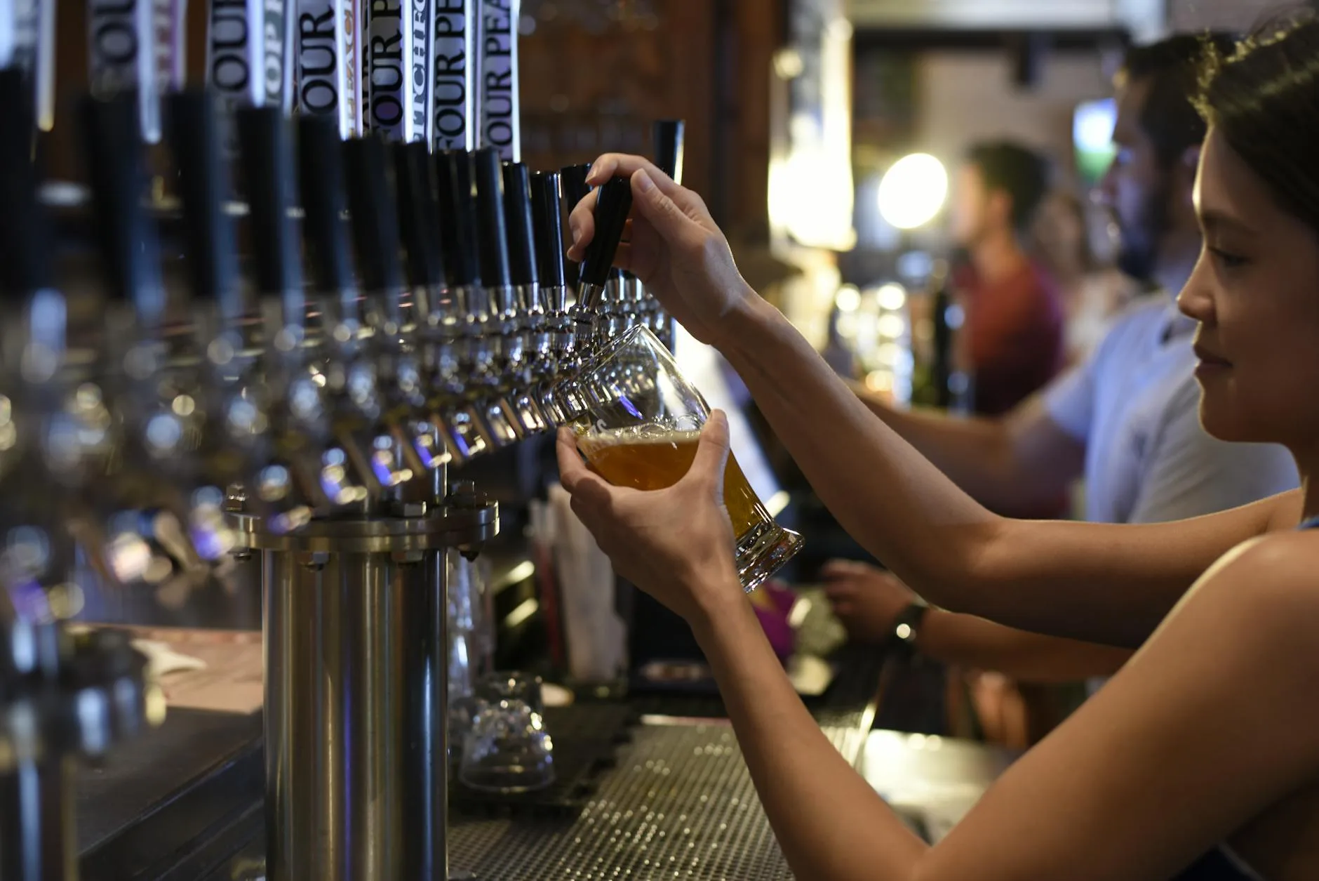 Beer being poured from a tap into a pint glass