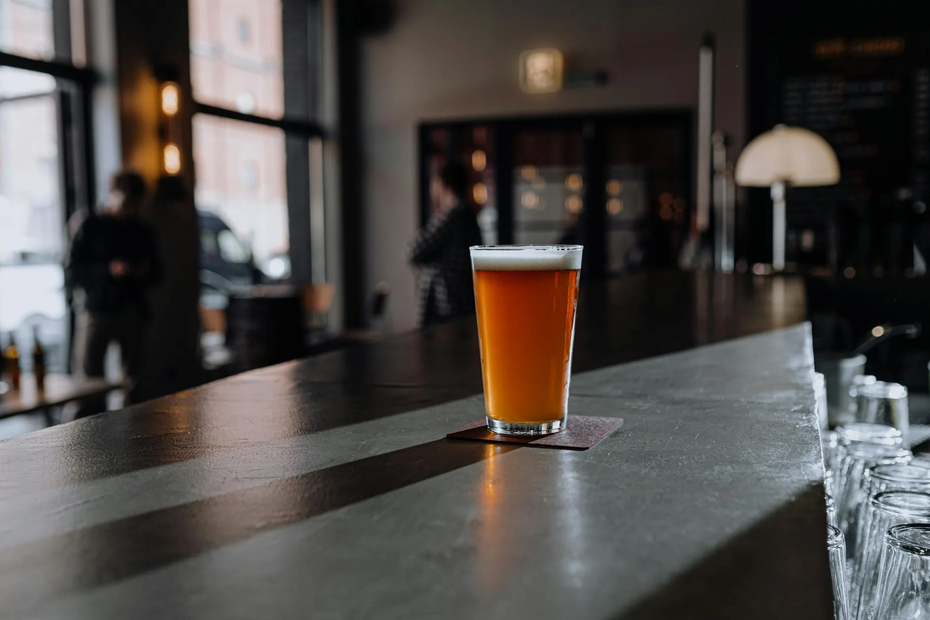 Glass of amber craft beer ready for tasting