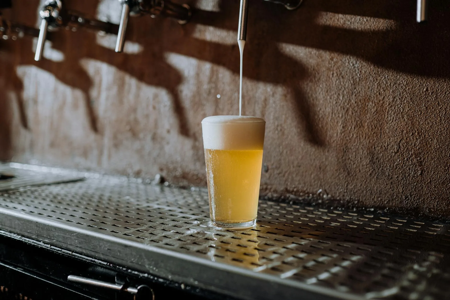 Home brewed amber ale being poured into a pint glass