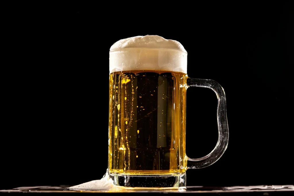 Glass of homebrew beer being examined for colour and clarity