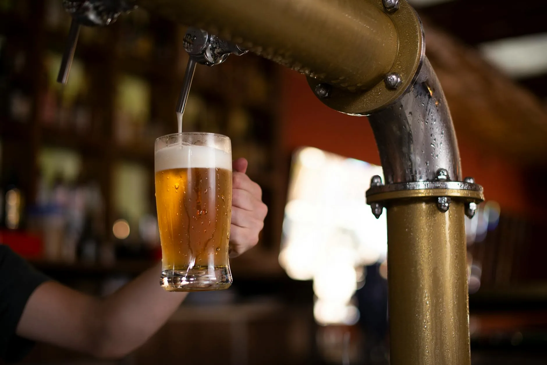 Amber homebrew beer being poured into a glass