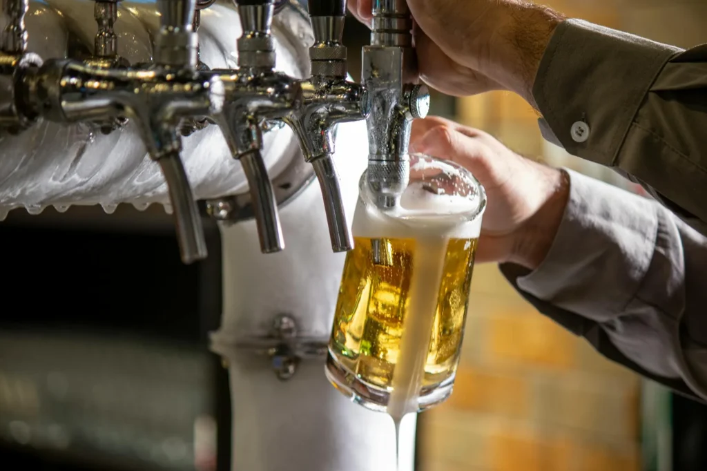 Draft beer being poured from a tap into a pint glass