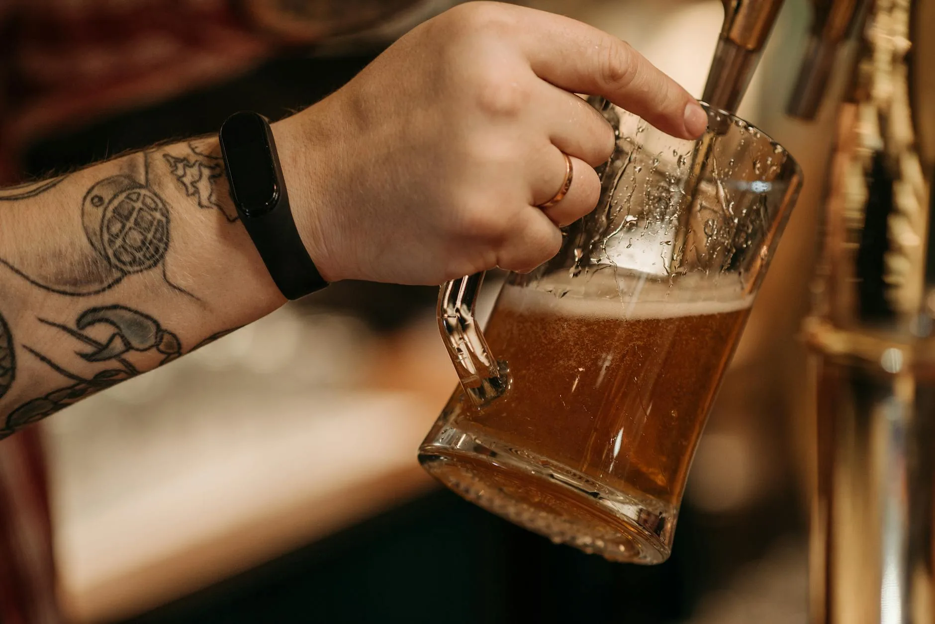 Pouring a glass of amber homebrew beer from a bottle