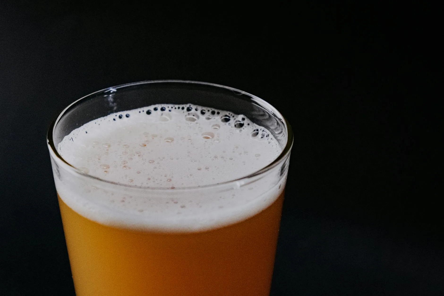 Active yeast fermentation bubbling in a homebrew vessel