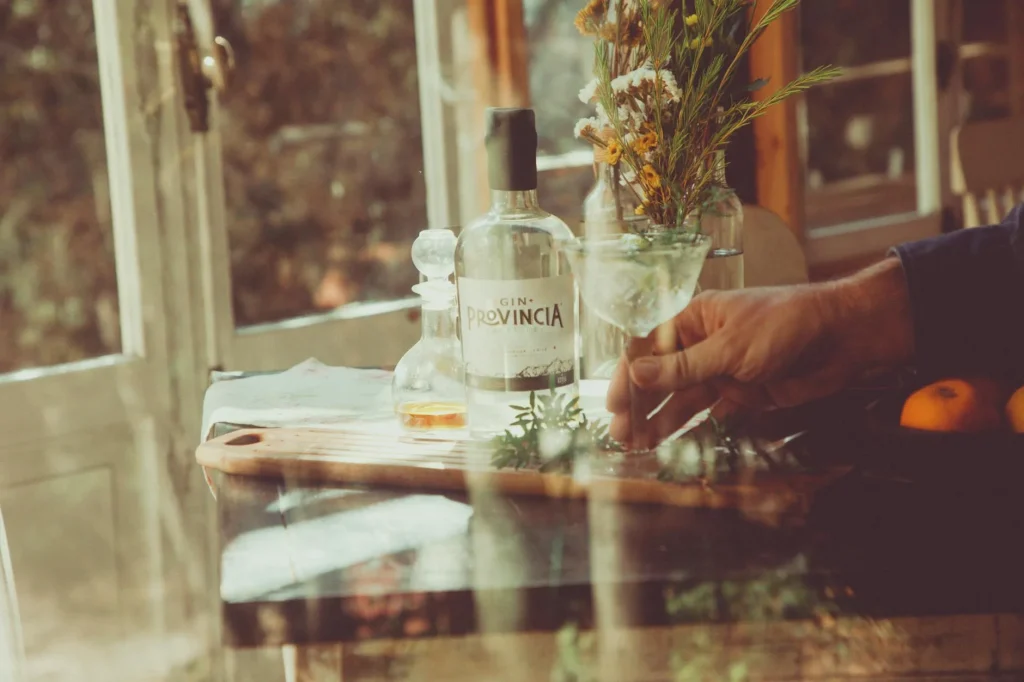 Gin botanicals including juniper berries in glass jars