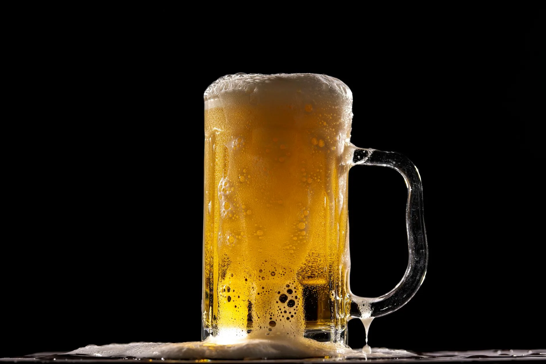 Homebrew beer fermenting in a glass carboy during active fermentation