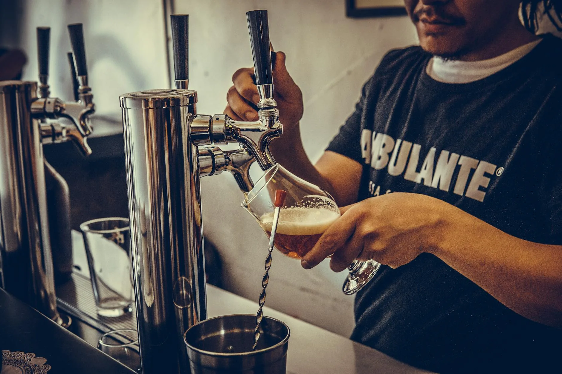 Beer being poured from a tap into a glass