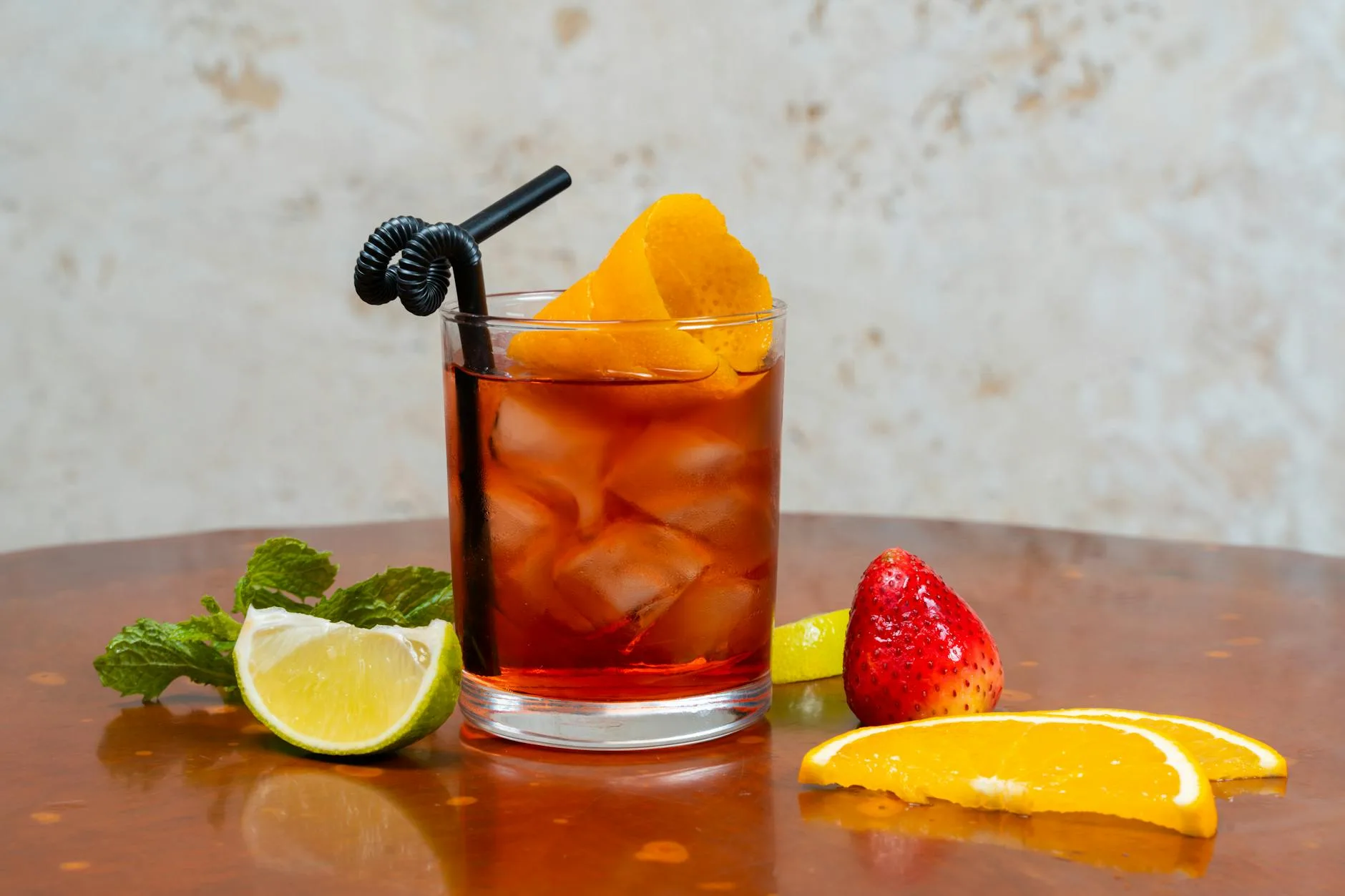 Spiced rum cocktail with ice and lime in a glass