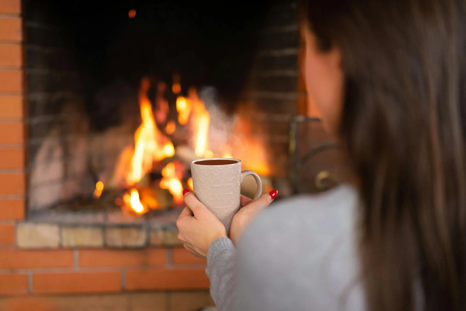 Cosy winter scene by a fireplace perfect for dark beer season