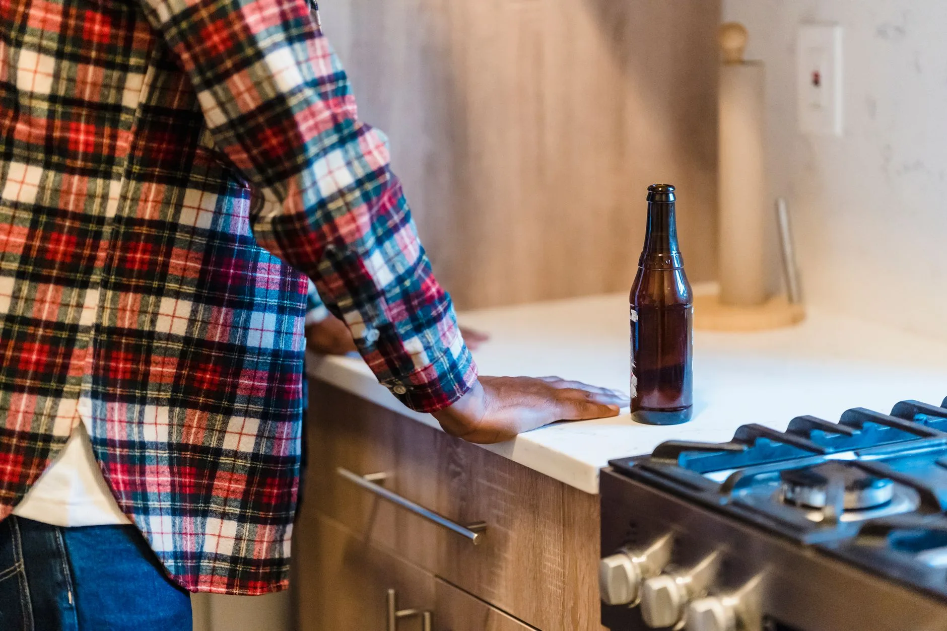 Brown beer bottle on a kitchen worktop during homebrew bottling